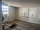 Bedroom with wood-look floors, a window, and some decorations at 916 Kentucky St, Haines City, FL 33844
