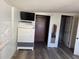 Bedroom with closet, dresser, TV, and wood floors at 916 Kentucky St, Haines City, FL 33844