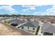 Aerial view of the house in a quiet neighborhood showcasing the backyard, roof, and fence lines at 9181 Se 166Th Sprung Ln, The Villages, FL 32162