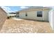 View of the home's backyard with concrete patio, privacy fence, and a low-maintenance yard at 9181 Se 166Th Sprung Ln, The Villages, FL 32162