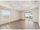Light-filled bedroom with tray ceiling, ceiling fan and sliding glass doors to the outdoor patio at 9181 Se 166Th Sprung Ln, The Villages, FL 32162