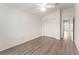 This bedroom has wood-look floors, a ceiling fan, and a closet at 9181 Se 166Th Sprung Ln, The Villages, FL 32162