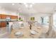 Digitally staged dining area showcasing an open-concept living area and kitchen at 9181 Se 166Th Sprung Ln, The Villages, FL 32162