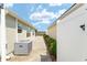 The home's exterior includes a walkway, an AC unit, and a white fence at 9181 Se 166Th Sprung Ln, The Villages, FL 32162