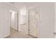 Bright hallway with wood-look floors and white doors provides access to bedrooms and bathrooms at 9181 Se 166Th Sprung Ln, The Villages, FL 32162
