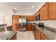 Spacious kitchen featuring stainless steel appliances, wood cabinets, and granite countertops at 9181 Se 166Th Sprung Ln, The Villages, FL 32162