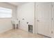 The laundry room includes a sink, tile floor, and a door to the outside at 9181 Se 166Th Sprung Ln, The Villages, FL 32162