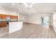 Bright, open-concept living space with wood floors, ceiling fan, and sliding glass doors at 9181 Se 166Th Sprung Ln, The Villages, FL 32162