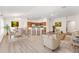 Digitally staged interior showcasing an open-concept living area with kitchen and dining at 9181 Se 166Th Sprung Ln, The Villages, FL 32162