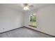 Cozy bedroom with gray carpet, ceiling fan and a window with natural light at 9236 County Road 48, Yalaha, FL 34797