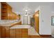 Bright kitchen featuring natural wood cabinets, laminate counters, and a full suite of stainless steel appliances at 9236 County Road 48, Yalaha, FL 34797