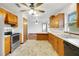Spacious kitchen featuring natural wood cabinets, neutral countertops, and a view that connects to the living area at 9236 County Road 48, Yalaha, FL 34797