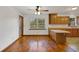 Eat-in kitchen with natural wood cabinets, laminate counters, modern lighting and flooring that transitions from wood at 9236 County Road 48, Yalaha, FL 34797