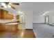 Open-concept living room with hardwood floors, ceiling fans, and a view into the kitchen at 9236 County Road 48, Yalaha, FL 34797