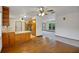 Open-concept living room with hardwood floors, ceiling fans, and a view into the kitchen at 9236 County Road 48, Yalaha, FL 34797