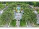 Aerial view of a building with a pool surrounded by palm trees and green landscaping at 1021 Siena Park Blvd # 204, Kissimmee, FL 34747