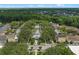 An aerial view shows buildings, a pool and palm trees in this real estate listing at 1021 Siena Park Blvd # 204, Kissimmee, FL 34747