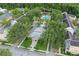 Aerial view of condos with a center building and pool surrounded by palm trees and landscaping at 1021 Siena Park Blvd # 204, Kissimmee, FL 34747