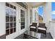 This balcony features outdoor seating and glass doors leading to the house at 1021 Siena Park Blvd # 204, Kissimmee, FL 34747