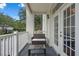 This balcony features a wicker bench and table perfect for outdoor seating at 1021 Siena Park Blvd # 204, Kissimmee, FL 34747