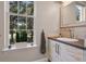 This bathroom features a sink and window with a view of the lush green yard at 1021 Siena Park Blvd # 204, Kissimmee, FL 34747