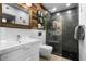Modern bathroom with wood accent wall, glass-enclosed shower, and contemporary fixtures create a spa-like ambiance at 1021 Siena Park Blvd # 204, Kissimmee, FL 34747