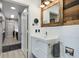 Modern bathroom featuring a vanity with sleek white finishes, a decorative wood accent wall, and contemporary fixtures at 1021 Siena Park Blvd # 204, Kissimmee, FL 34747
