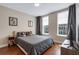 Cozy bedroom featuring hardwood floors, natural light through two windows, and playful cartoon decor for a cheerful atmosphere at 1021 Siena Park Blvd # 204, Kissimmee, FL 34747