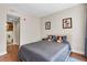 Well-lit bedroom showcases hardwood floors, cartoon wall decor, and a doorway leading to a bathroom at 1021 Siena Park Blvd # 204, Kissimmee, FL 34747