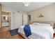 Bedroom with hardwood floors with a castle wall decal and a doorway leading to a stylish bathroom at 1021 Siena Park Blvd # 204, Kissimmee, FL 34747