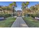 A well-maintained community clubhouse with a manicured lawn and a decorative fountain feature at 1021 Siena Park Blvd # 204, Kissimmee, FL 34747
