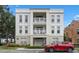 Exterior view of a condominium building with a red car, and balconies at 1021 Siena Park Blvd # 204, Kissimmee, FL 34747