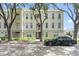 Beautiful exterior view of a multi-story condo building with mature landscaping, a black car, and balconies at 1021 Siena Park Blvd # 204, Kissimmee, FL 34747