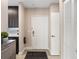 Foyer with a decorative rug, brown cabinetry, and a white closet at 1021 Siena Park Blvd # 204, Kissimmee, FL 34747