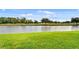 Scenic view of the golf course next to a pond and lush greenery at 1021 Siena Park Blvd # 204, Kissimmee, FL 34747