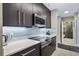Modern kitchen with stainless steel appliances, white quartz countertops and access to bath at 1021 Siena Park Blvd # 204, Kissimmee, FL 34747