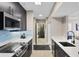 Modern kitchen design with stainless steel appliances and quartz countertops, that leads into a bathroom at 1021 Siena Park Blvd # 204, Kissimmee, FL 34747