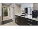 Modern kitchen with dark cabinets, stainless steel appliances, and a seamless transition to the open living area at 1021 Siena Park Blvd # 204, Kissimmee, FL 34747
