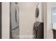 Convenient laundry closet beside a stainless steel fridge with stacked washer and dryer at 1021 Siena Park Blvd # 204, Kissimmee, FL 34747