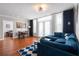 Living room with blue sofa, dining area and a view into a bedroom at 1021 Siena Park Blvd # 204, Kissimmee, FL 34747