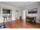 A well lit living room with wood floors, an adjacent dining area and bar seating, and an open floor plan at 1021 Siena Park Blvd # 204, Kissimmee, FL 34747
