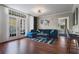 Comfortable living room featuring a blue sectional sofa and access to the outside via french doors at 1021 Siena Park Blvd # 204, Kissimmee, FL 34747