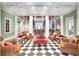 This community lobby is styled with checkered floors and holiday decor at 1021 Siena Park Blvd # 204, Kissimmee, FL 34747