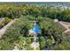 A beautiful aerial view of a community pool surrounded by palm trees and lush landscaping at 1021 Siena Park Blvd # 204, Kissimmee, FL 34747