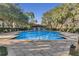 A beautiful community pool surrounded by trees and shrubbery creates a luxurious outdoor space at 1021 Siena Park Blvd # 204, Kissimmee, FL 34747