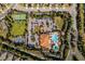 Aerial view of tennis courts and community center with pool and parking at 1027 Timbervale Trl, Clermont, FL 34715