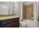 Well-maintained bathroom features a vanity with a neutral-colored countertop, a tub, and tiled shower at 1027 Timbervale Trl, Clermont, FL 34715