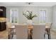 Bright dining room with natural light and a wooden table, complemented by modern furnishings at 1027 Timbervale Trl, Clermont, FL 34715