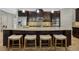 Spacious kitchen island with seating, granite counters, dark cabinets, and stainless steel appliances at 1027 Timbervale Trl, Clermont, FL 34715