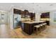 Spacious kitchen with a large center island, ample seating, dark wood cabinets, and modern appliances at 1027 Timbervale Trl, Clermont, FL 34715